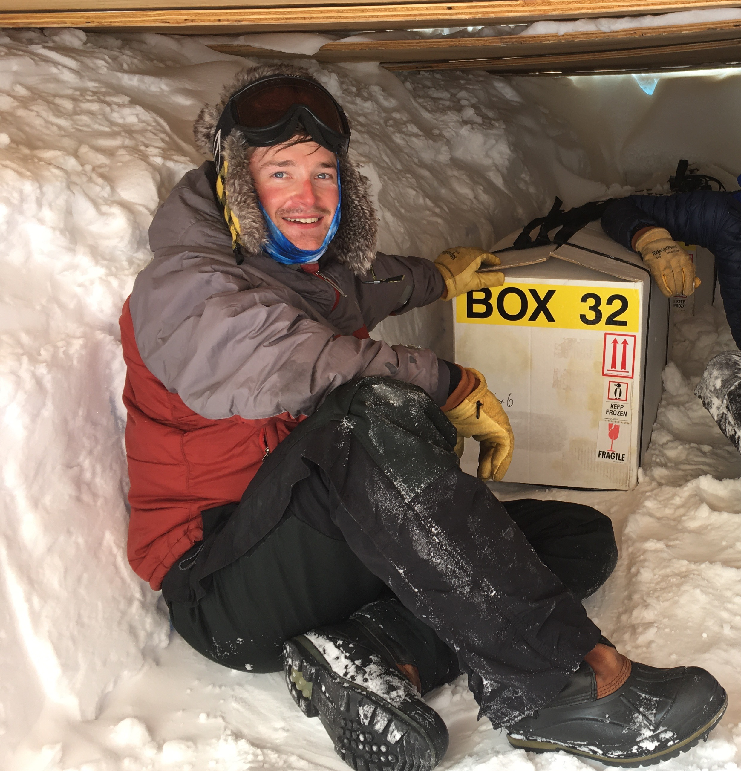Sitting with a core box in an ice core trench in Allan Hills, Antarctica. Photo: Austin Carter